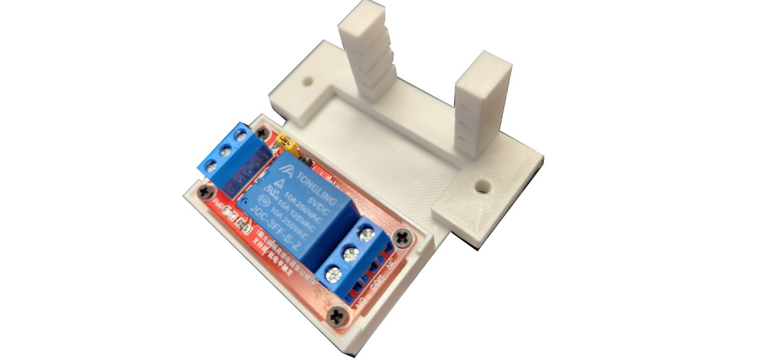 A white plastic holder with two blue relays.
